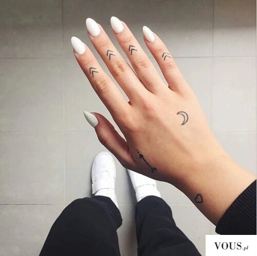 Białe paznokcie i delikatne tatuaże na dłoni
